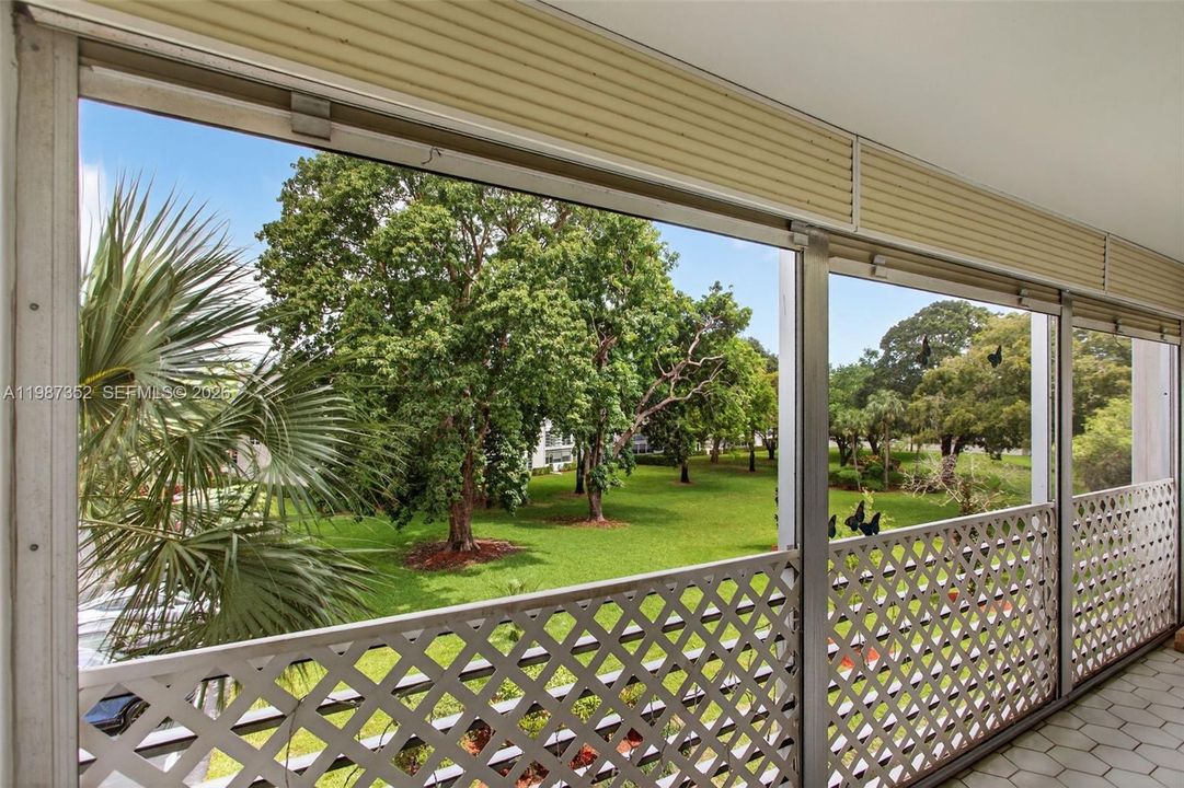Large screened balcony with 2 sliding glass doors and storage closet
