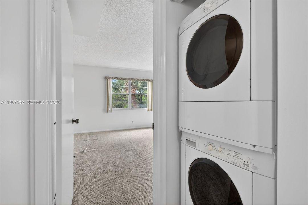 In unit laundry with newer stacked washer/dryer.