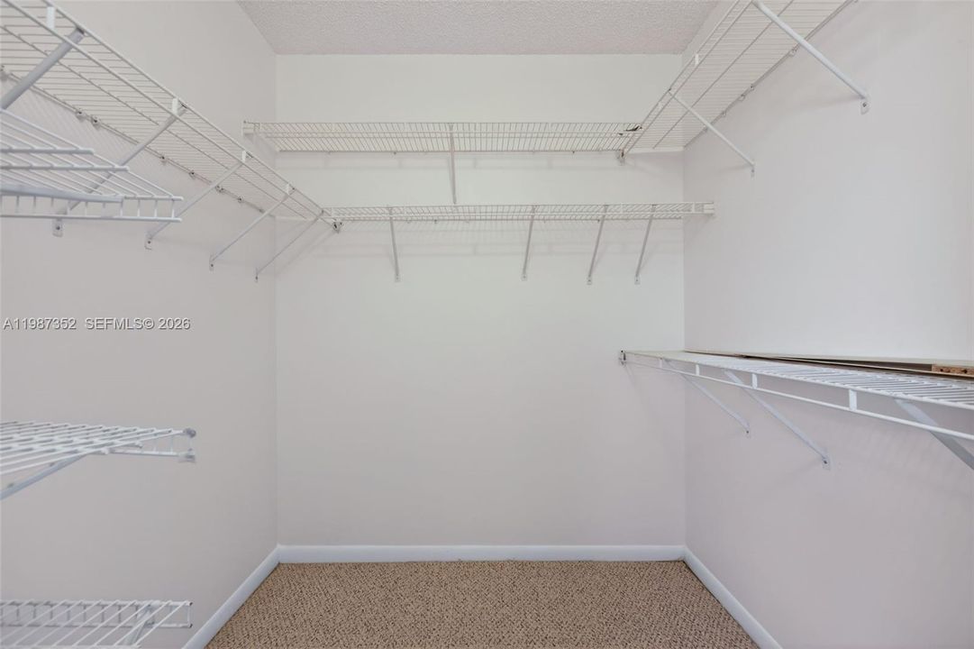 Primary bedroom walk-in closet
