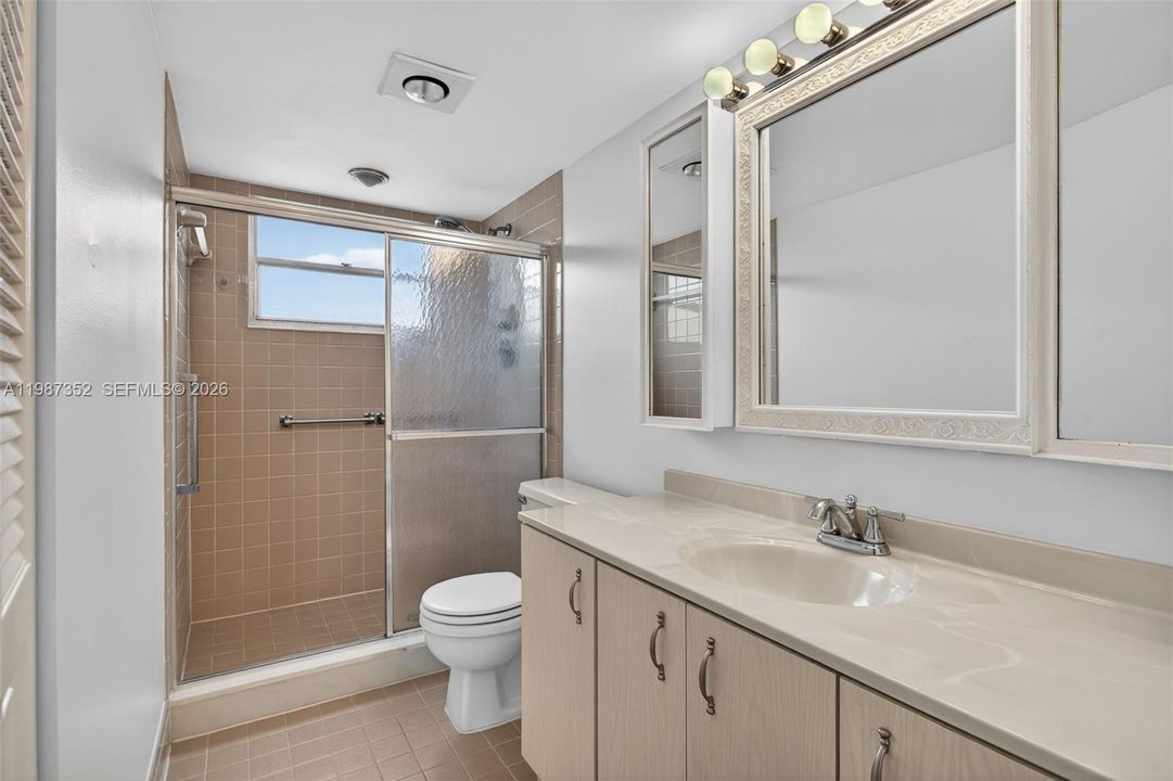 Natural light, walk-in shower, and linen closet
