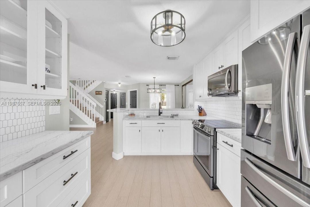 Open Kitchen with convenient access to back patio.