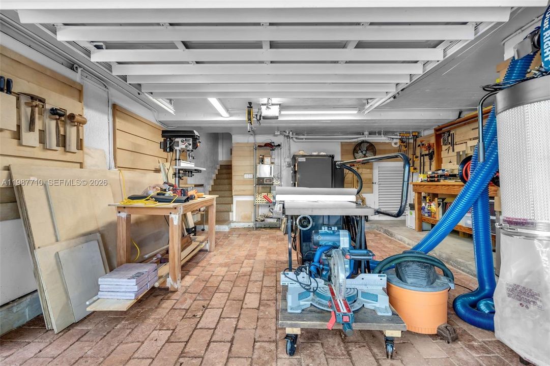 Two garages exist: one utilized by owners as a wood shop and ceramic kiln, equipped with a higher voltage capacity.