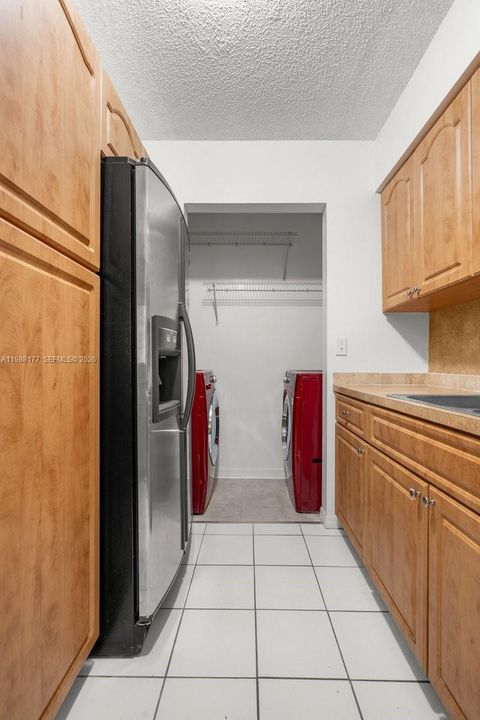 Kitchen with View of Washer and Dryer