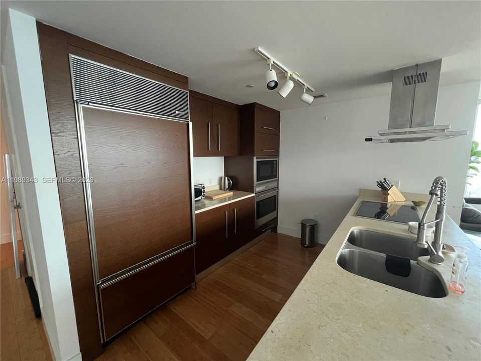 Open kitchen with cooking island with marble top