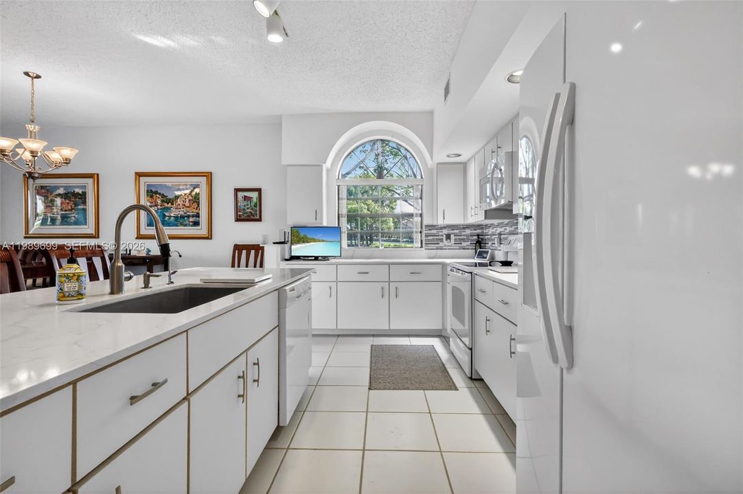 This home features oversized windows, elevated ceilings