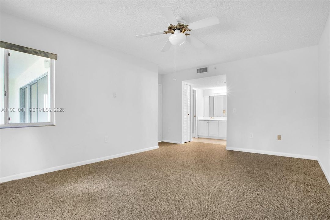 PRIMARY BEDROOM W/WINDOW TO BALCONY