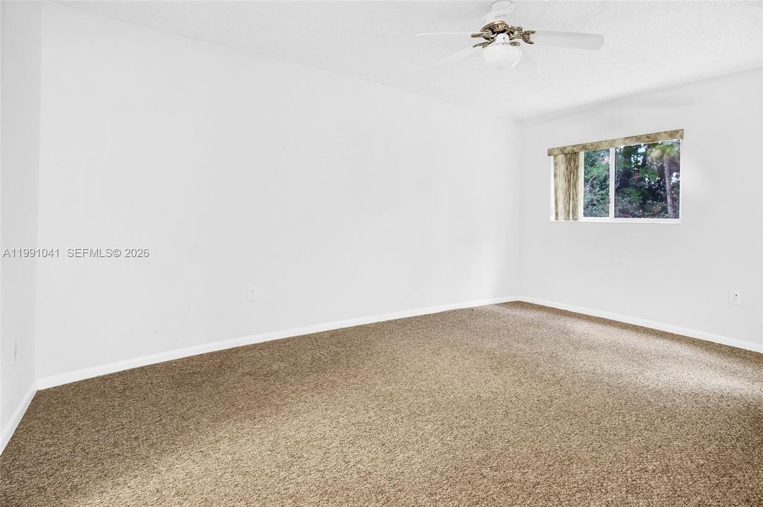 WELL LIGHTED PRIMARY BEDROOM W/WINDOW