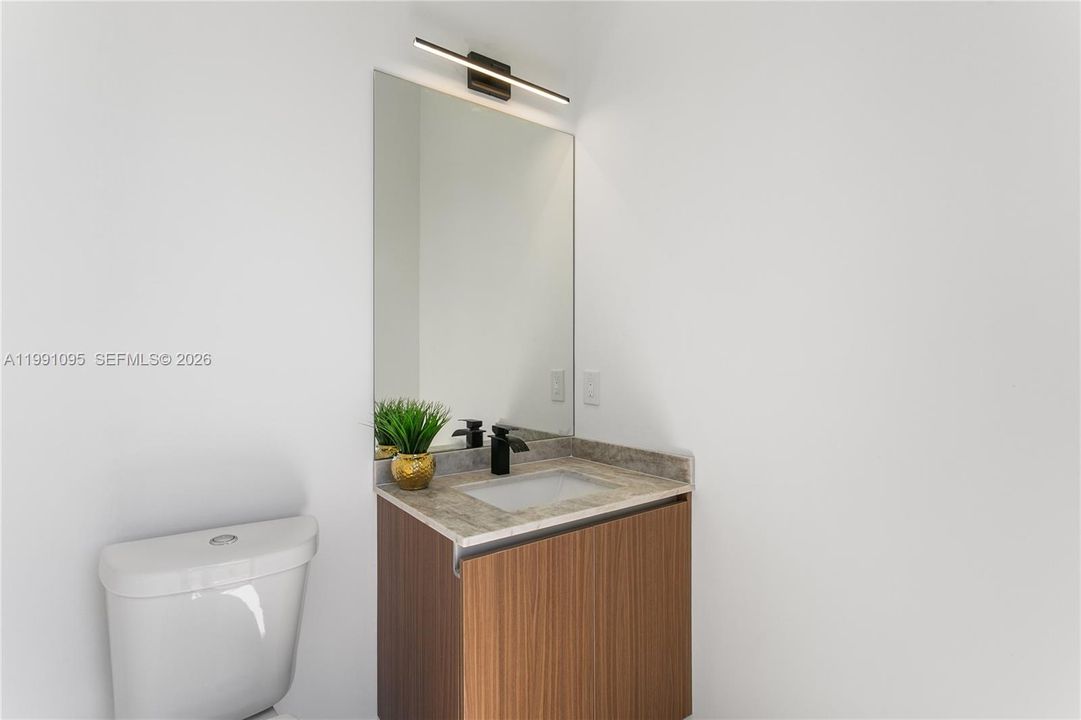 Convenient cabana half bathroom provides easy access from the pool area, perfect for guests and outdoor entertaining.