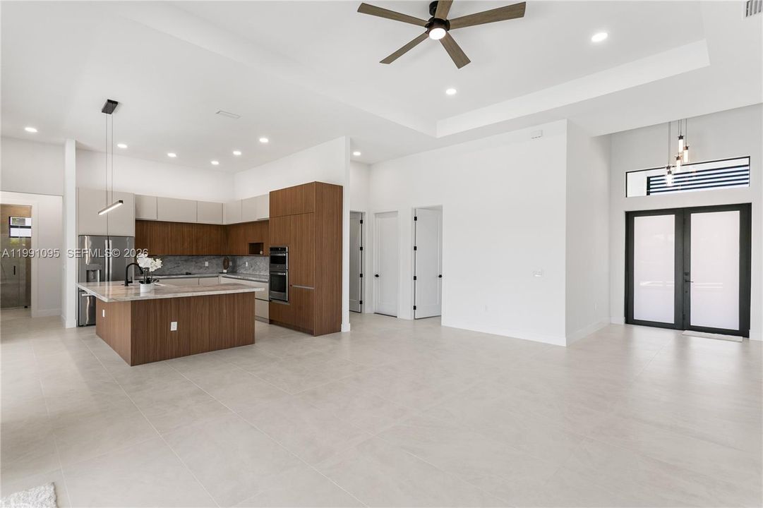 High-end finishes include MATTE PORCELAIN TILE throughout, IMPACT-RESISTANT Low-E windows & doors, BAHAMA SHUTTERS & a welcoming COLUMNED FRONT PORCH w/ frosted DOUBLE ENTRY DOORS.