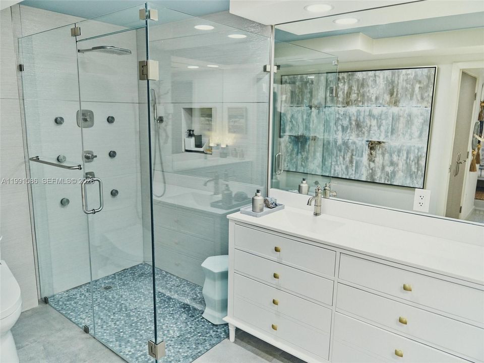 In suite luxurious master bath features TOTO Washlet system; zero step walk in spa like shower.