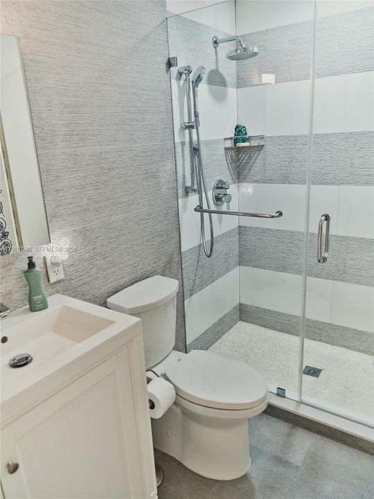 Second bath and bedroom designed with option to privatize.  Porcelanosa tile and walk in shower.