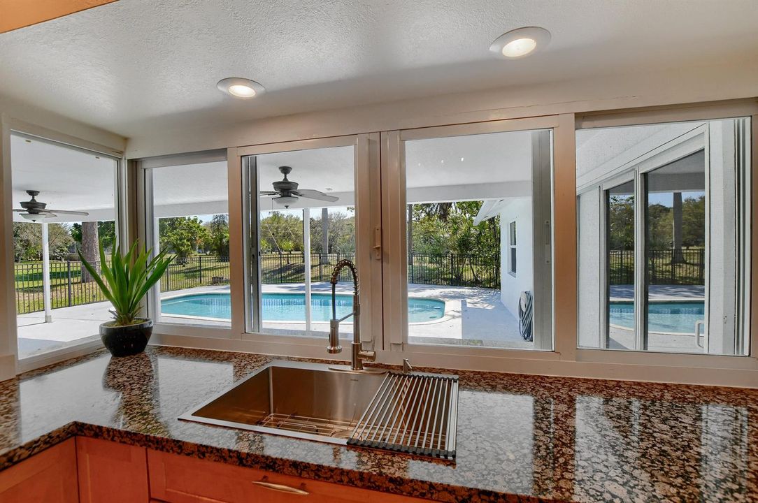 Kitchen with a pool view