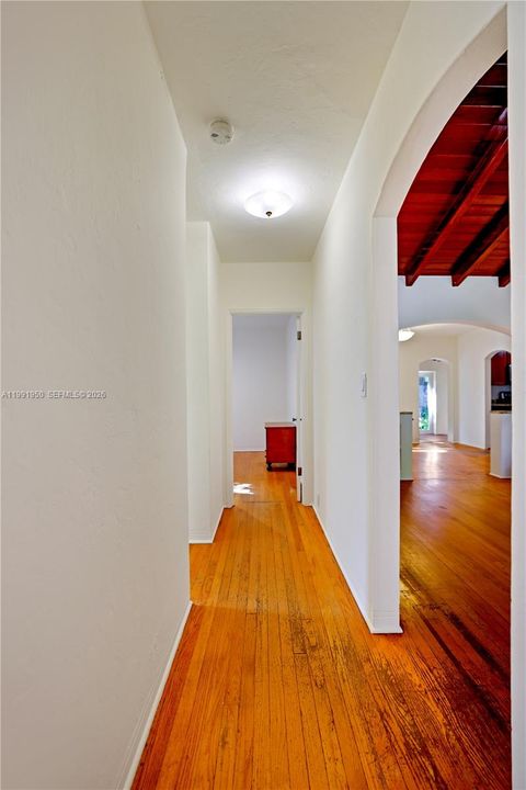 Interior hallway with clean layout and hardwood flooring