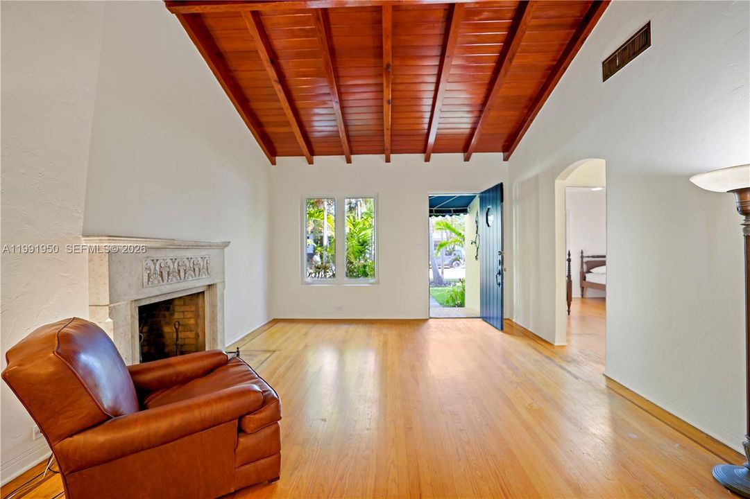 Open living space with wood ceilings and bright indoor-outdoor feel