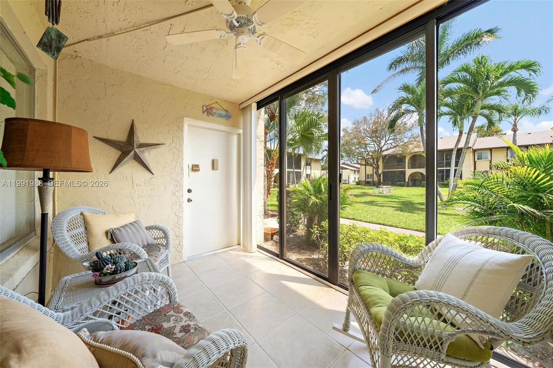 A screened patio with sliding screens and glass doors.