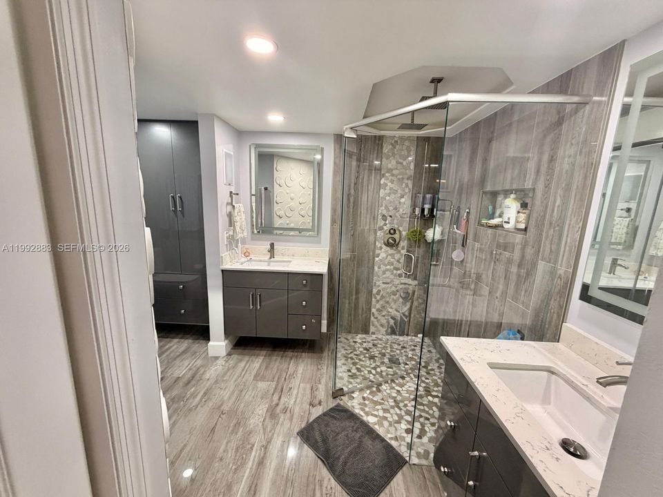 Beautifully tiled with natural stone and custom cabinets