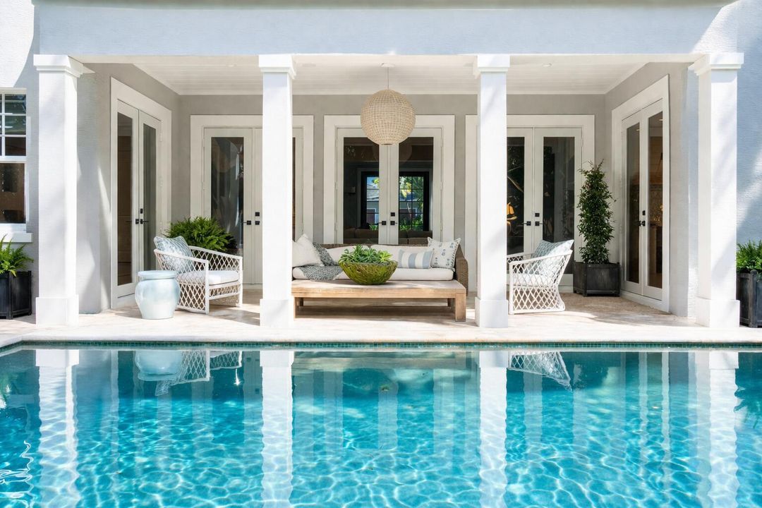 Modern coastal patio with pool reflectio