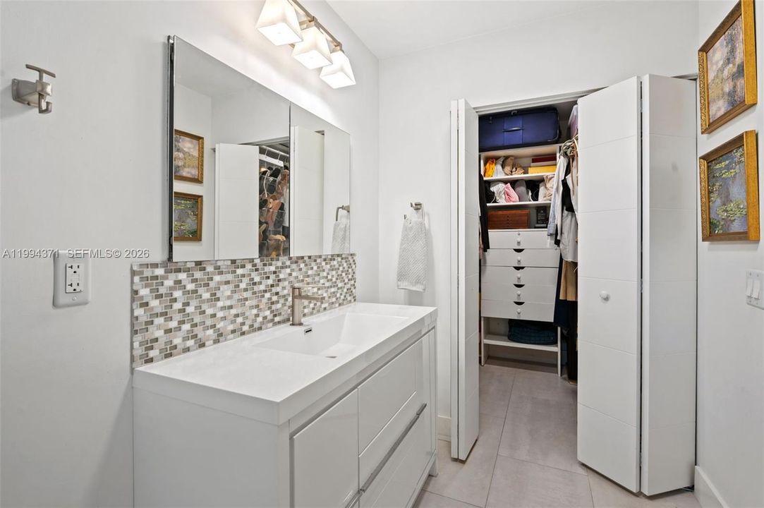 Primary walk-in closet with custom build-out