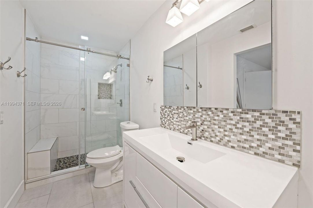 En-suite primary bathroom with step-in shower