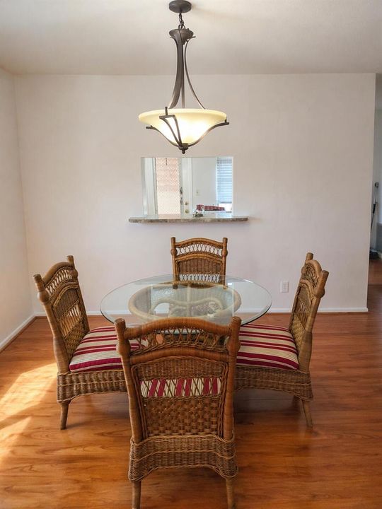 Minimalist dining room with wicker accen