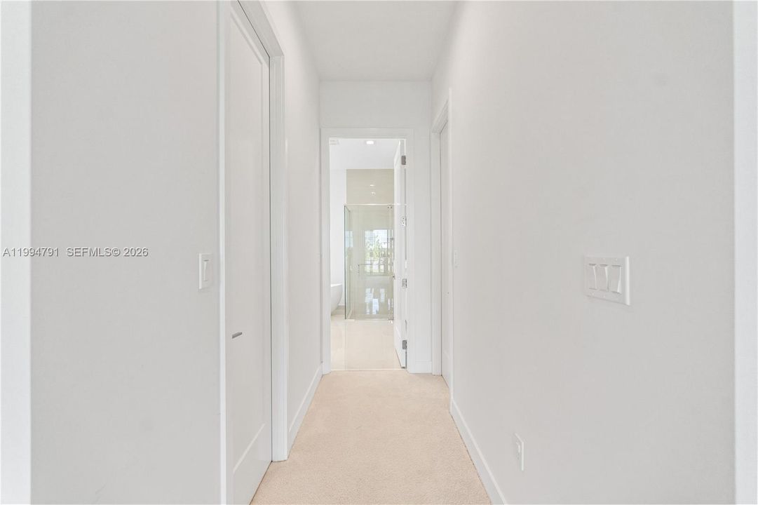 Two walk-in closets in hallway to ensuite bath