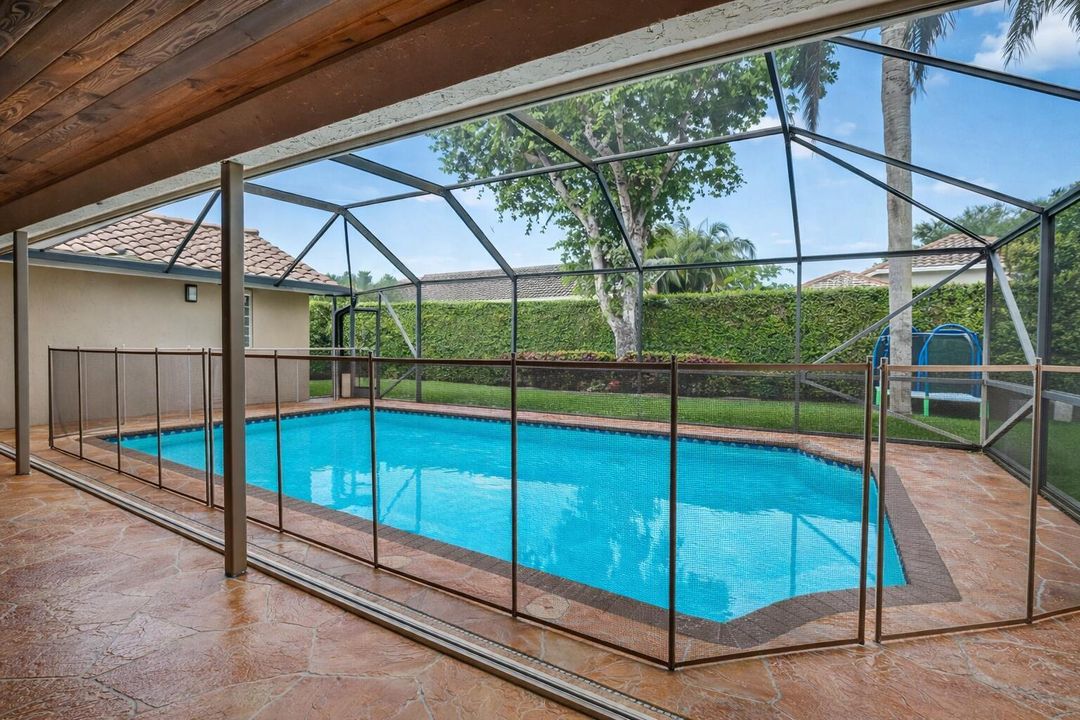 Serene poolside view with bronze fence