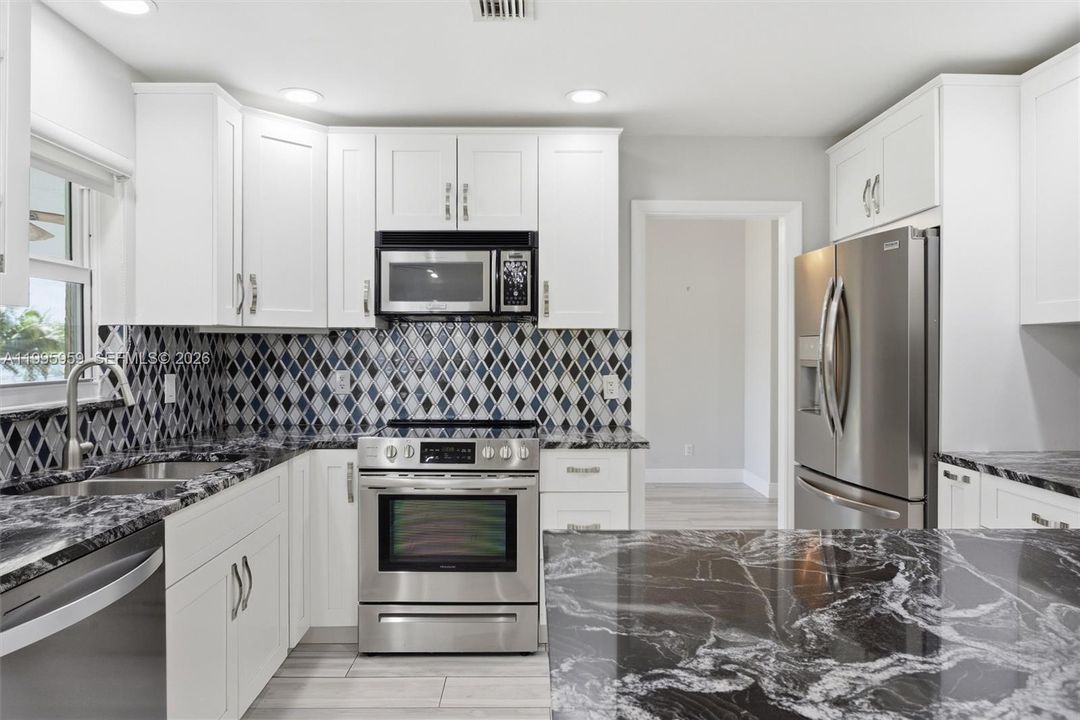 Notice Frigidaire SS Appliances & Beautiful Mottled Counter Tops