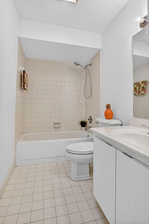 Guest bath with tile to the ceiling.