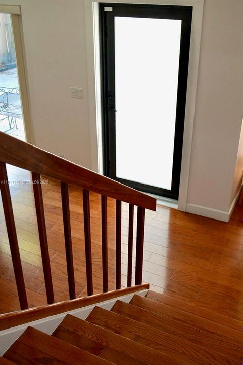 View from stairs to front door; Hurricane impact door