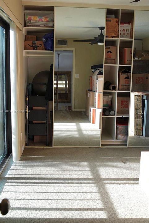 Custom closet shelving and sliding mirror doors