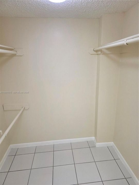 walk in closet with pocket door in vanity area