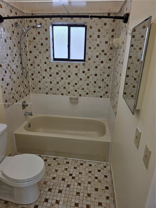 with tub and brand new toilet just installed