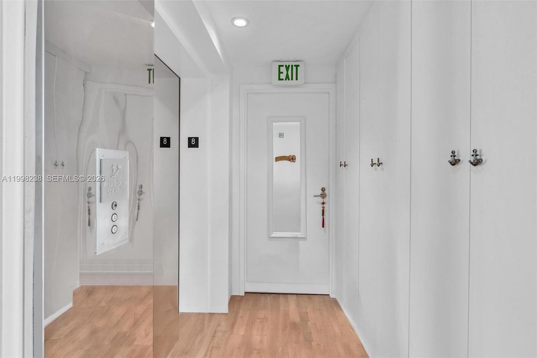 Private elevator foyer with custom shoe closets.