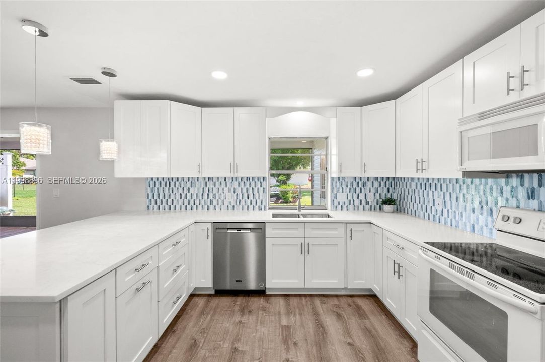 Quartz Countertops and tile backsplash in the kitchen