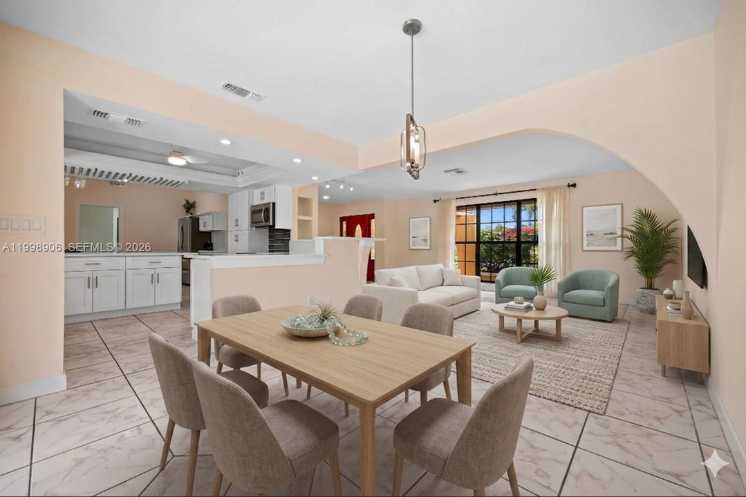 Virtually staged dining looking toward the front living area