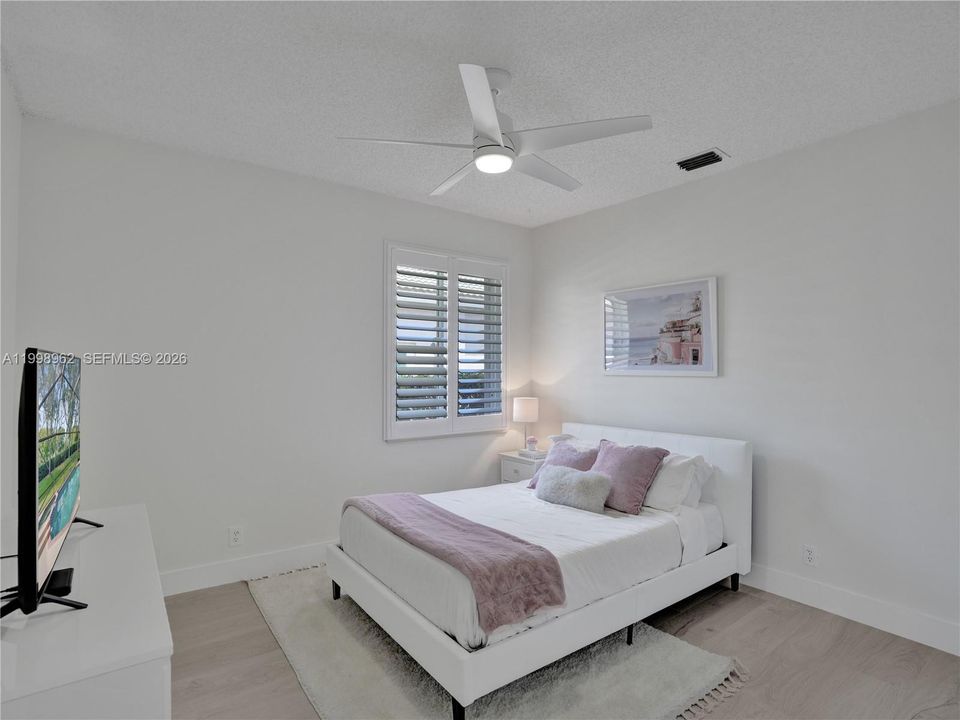 2nd bedroom, freshly painted and new flooring and baseboards, custom closets