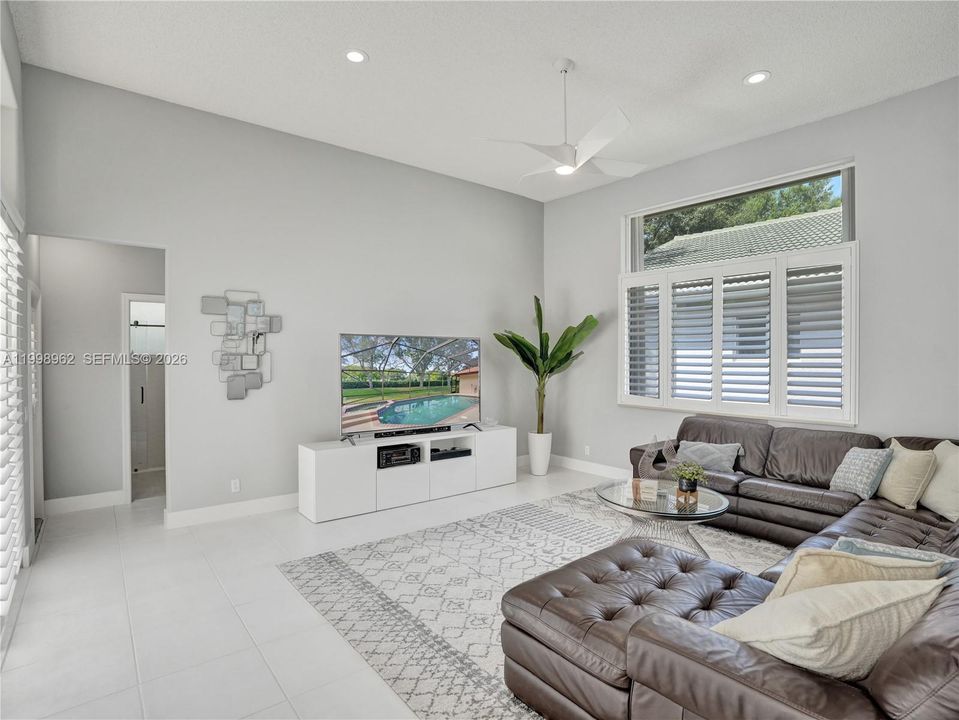 Family room overlooking the pool with large windows bringing in natural light