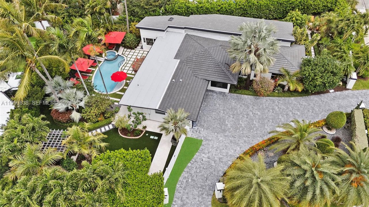 Aerial of 3001 Bayview featuring circular marble driveway, flat tile roof, and meticulously manicured grounds with several areas to enjoy the south Florida lifestyle. Other features include hot tub, sauna and outdoor shower.