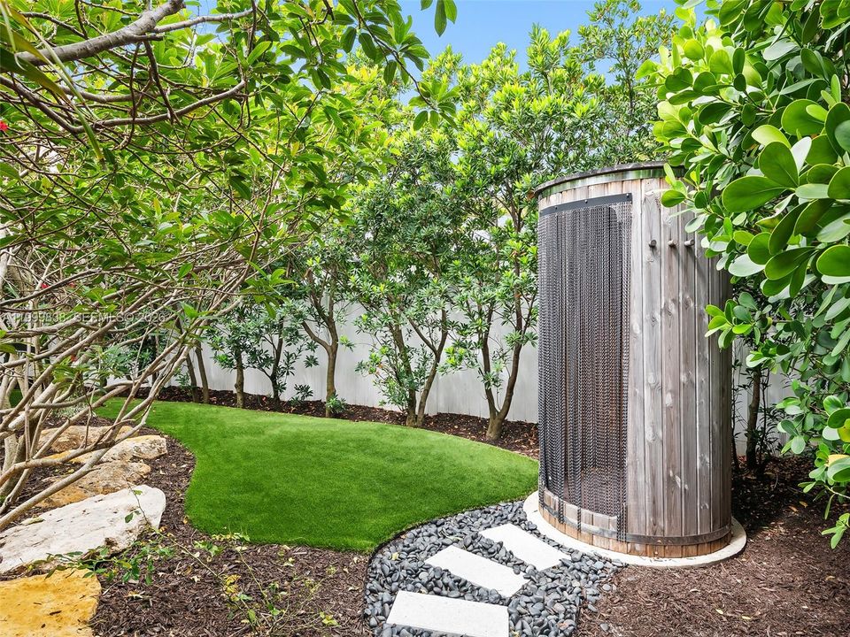 Outdoor heated shower in lushly landscaped gardens