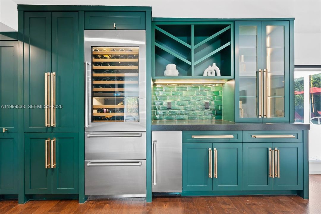 Custom cabinetry featuring fully integrated Sub Zero wine fridge with refrigerator and freezer drawers & ice maker