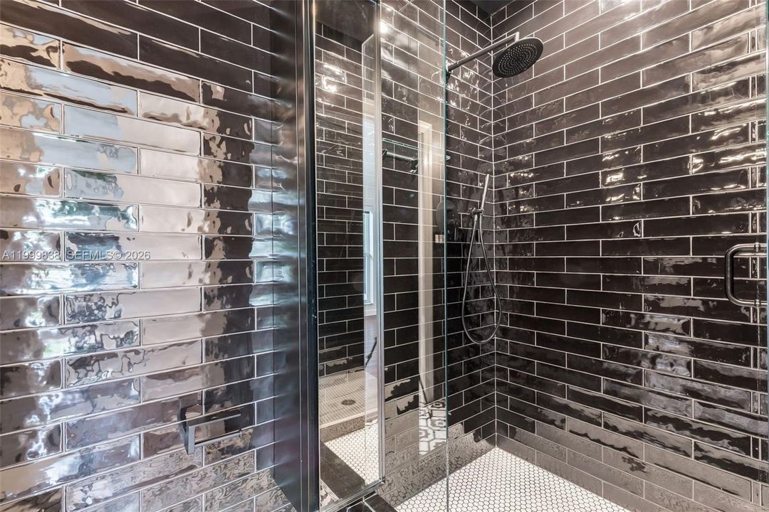 Seamless glass shower enclosure in full guest bath