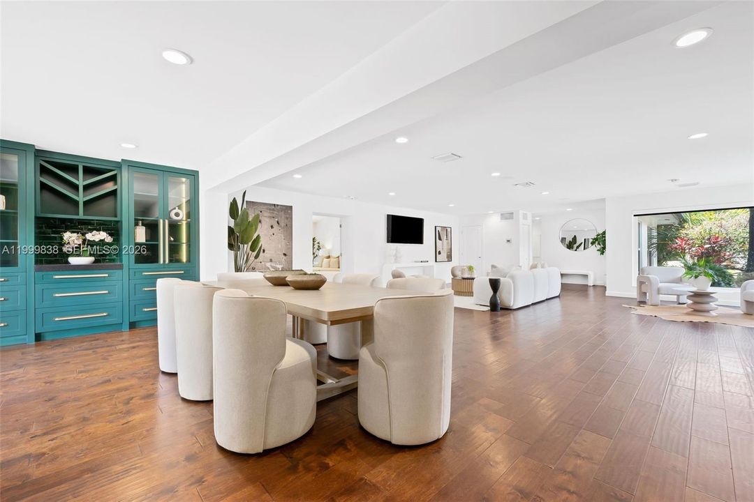 View from fining area to living area & view to custom built-ins with display cabinetry