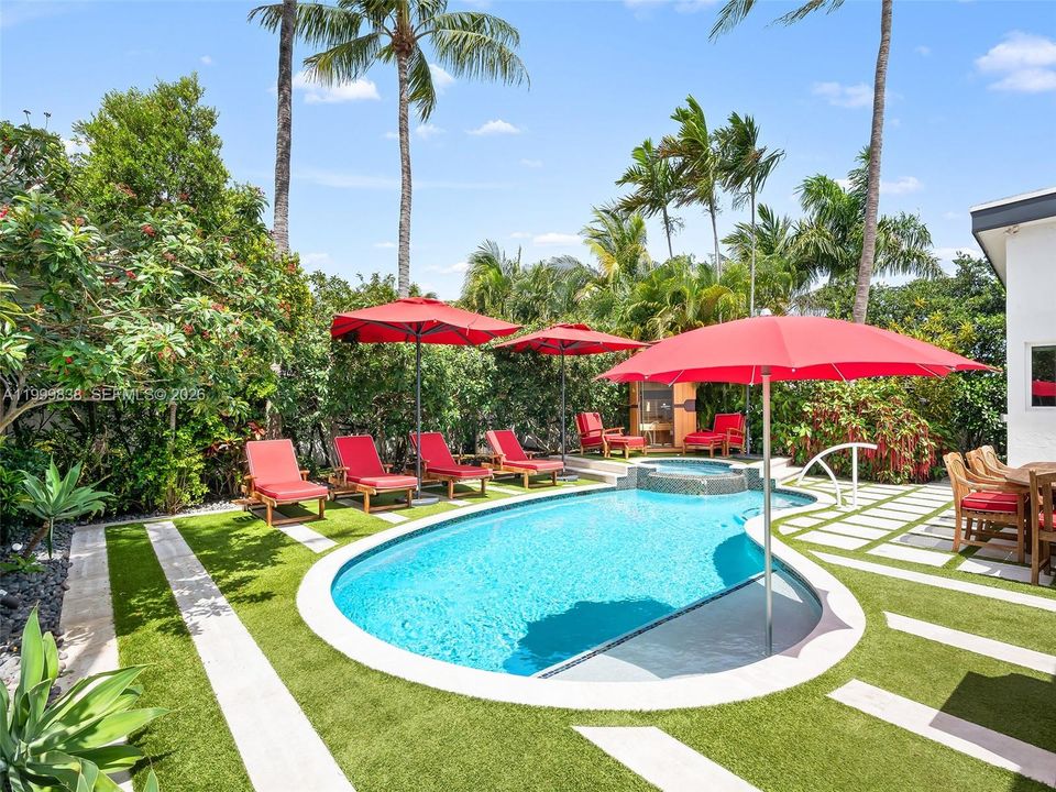 Resort style salt water pool featuring spa and outdoor sauna