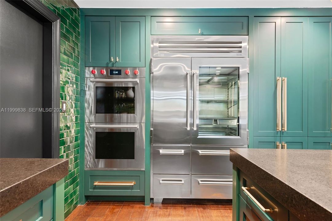 Fully integrated Sub Zero refrigerator & freezer drawers with double Wolf ovens.