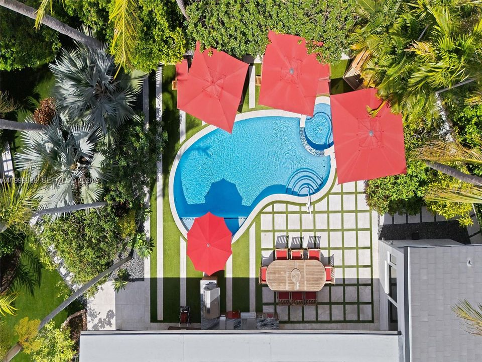 Aerial view of resort style pool featuring summer kitchen, outdoor sauna spa and hottub