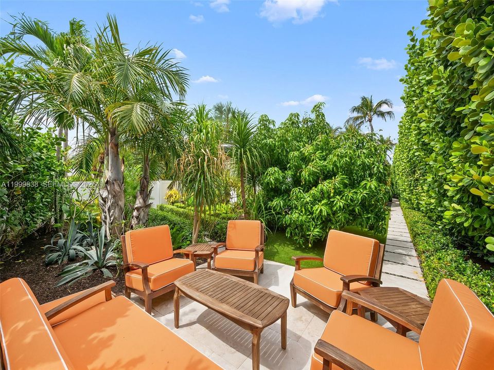 An entertainers seating area in the lushly landscaped gardens