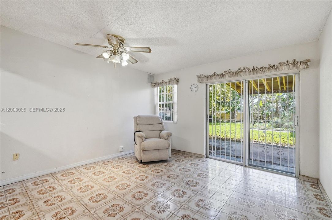 Spacious family room in front of kitchen with easy access to back yard