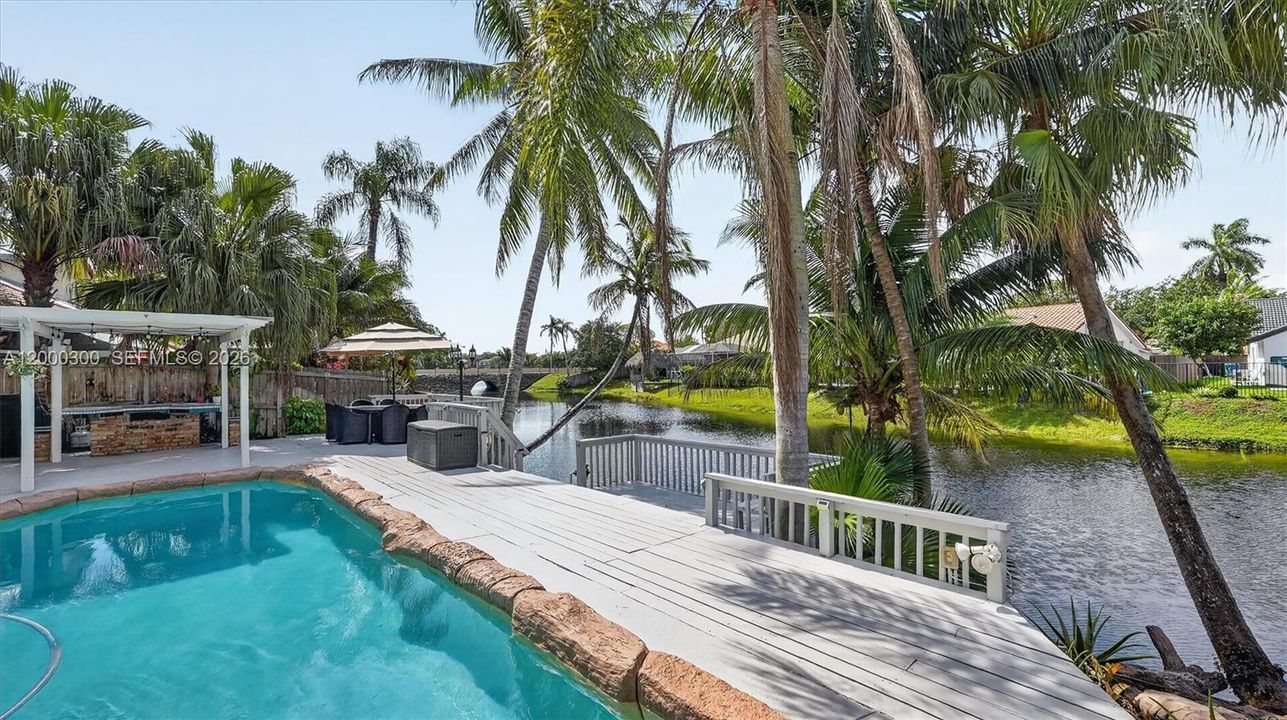 Pool, deck, lake, palm trees