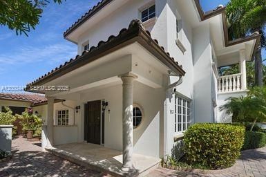 Entry covered with barrel tile roof.