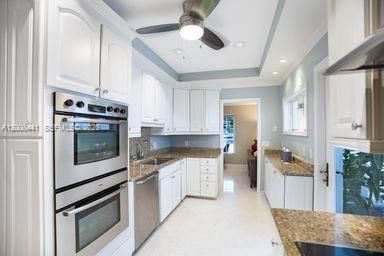 Bosch double wall oven and stove & Sub-Zero refrigerator compliments bright kitchen.
